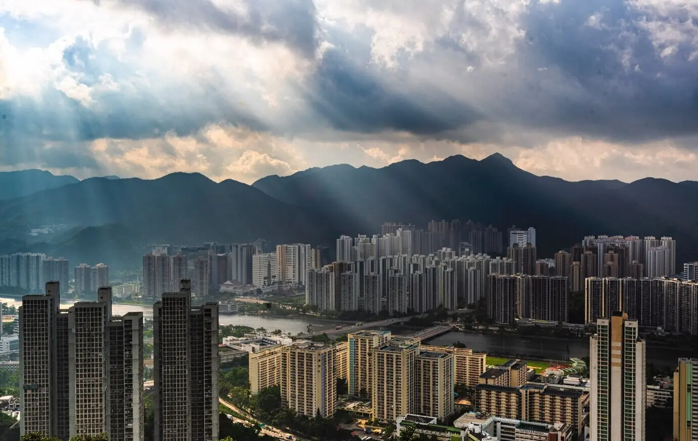 A beautiful aerial view of an apartment building area in an urban city with amazing clouds and sunlight.